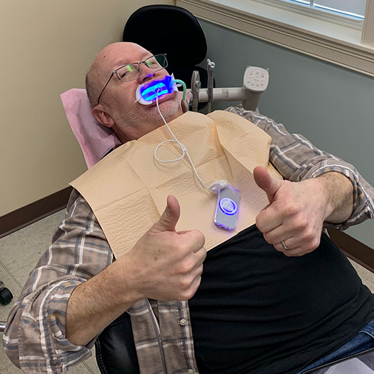 dental patient giving thumbs up